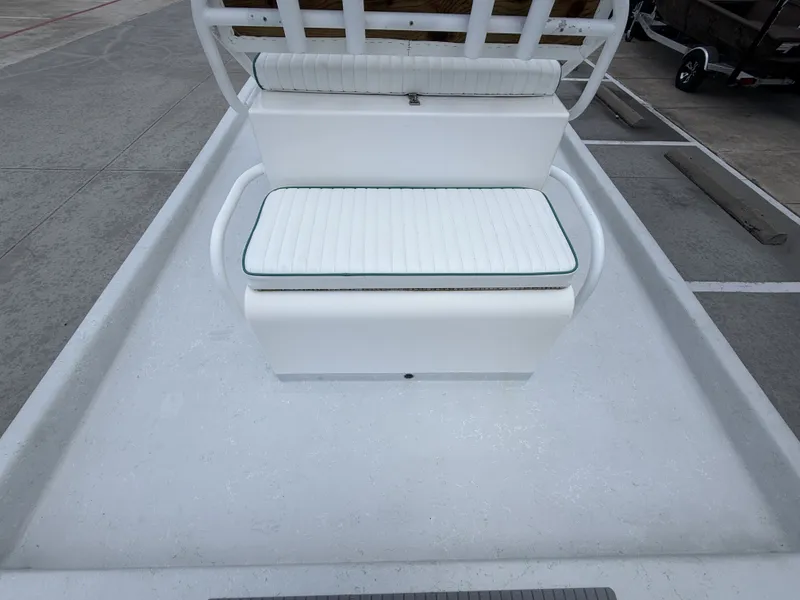Slide: The Image of The image shows a white bench seat on a boat, surrounded by a clean deck. - 13