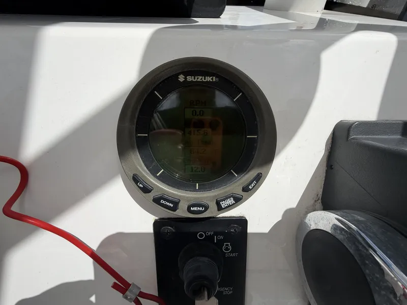 Slide: The Image of A Suzuki digital display shows engine data like RPM and voltage. A start switch is visible below. - 19