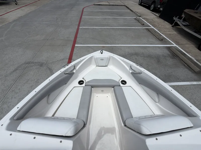 Slide: The Image of The 2019 Regal 1900ES SURF features a spacious bow seating area with gray upholstery. - 21