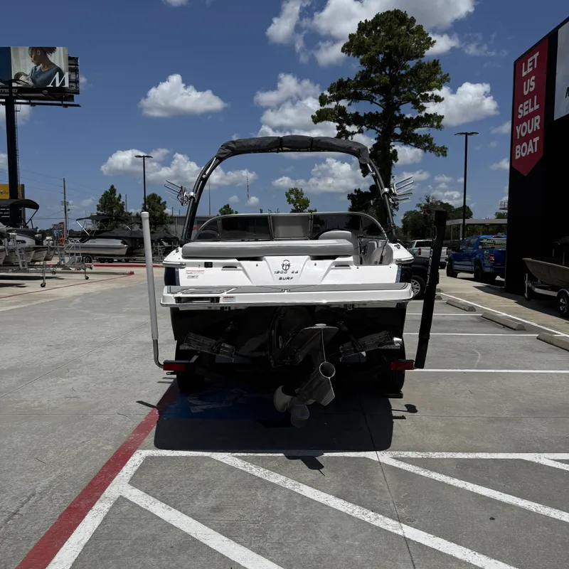 Slide: The Image of A 2019 Regal 1900ES SURF boat is parked on a lot. It features a tower and is on a trailer. - 9