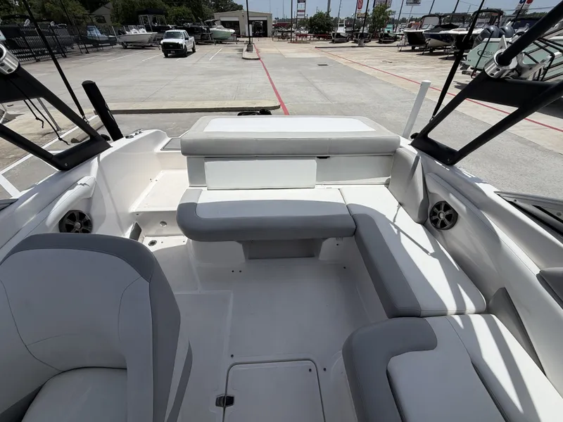 Slide: The Image of The image shows the cockpit of a 2019 Regal 1900ES SURF boat with gray and white seating. - 12