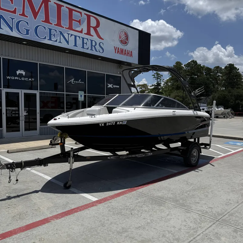 Slide: The Image of A 2019 Regal 1900ES SURF boat on a trailer in front of a building. - 3