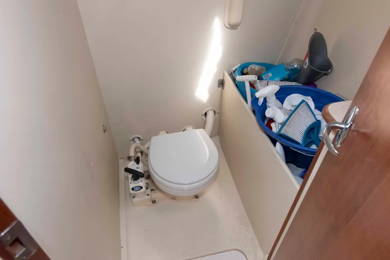 Slide: The Image of Small boat bathroom with toilet and cleaning supplies, Marlow-Hunter 27, 2013 model. - 19