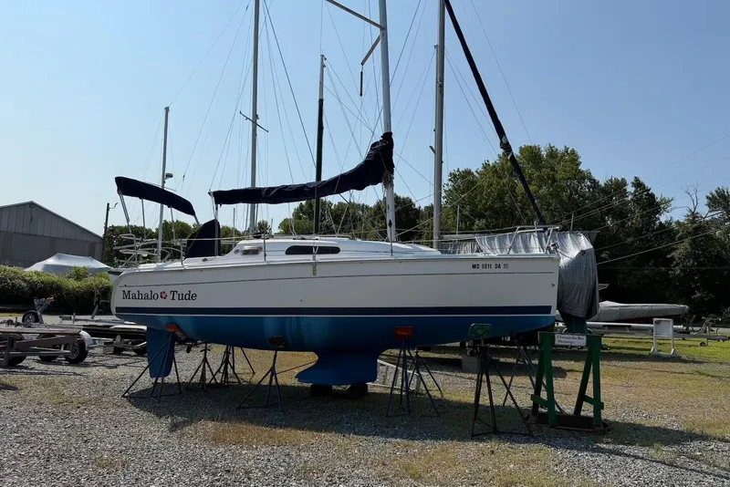 Slide: The Image of 2013 Marlow-Hunter 27 sailboat on stands in a boatyard, named "Mahalo Tude." - 3