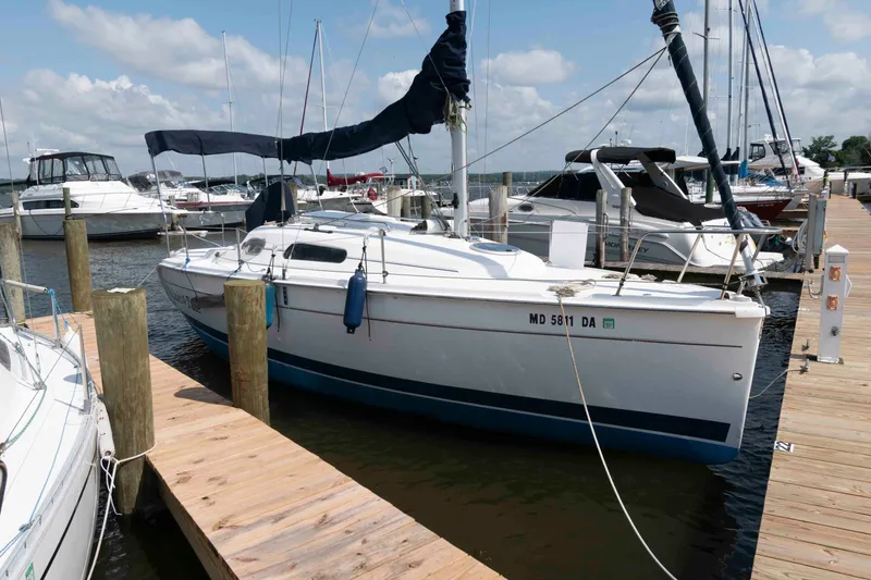 Slide: The Image of 2013 Marlow-Hunter 27 sailboat docked at a marina under a clear sky. - 1