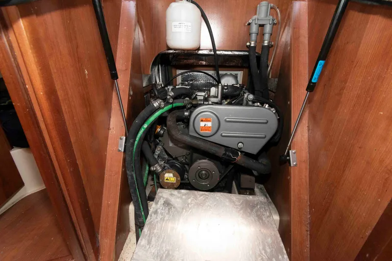 Slide: The Image of Engine compartment of a 2013 Marlow-Hunter 27 sailboat, featuring a compact marine engine. - 21