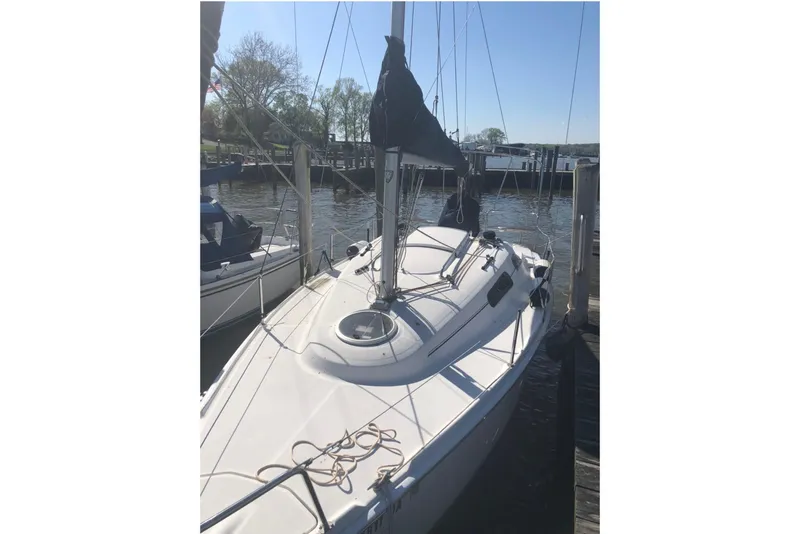 Slide: The Image of 2013 Marlow-Hunter 27 sailboat docked at a marina on a sunny day. - 11