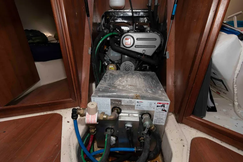 Slide: The Image of Engine compartment of a 2013 Marlow-Hunter 27 sailboat, showing mechanical components and wiring. - 22