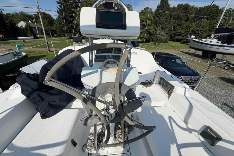 Slide: The Image of 2013 Marlow-Hunter 27 sailboat cockpit with steering wheel and navigation equipment. - 6