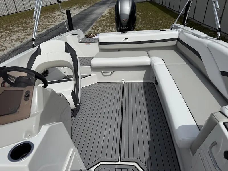 Slide: The Image of The image shows the cockpit of a 2023 Starcraft SVX 211 OB with gray flooring and white seating. - 12