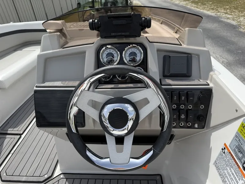 Slide: The Image of The image shows the helm of a 2023 Starcraft SVX 211 OB boat with modern instruments. - 6