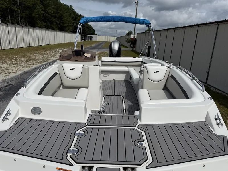 Slide: The Image of The image shows a 2023 Starcraft SVX 211 OB boat. It features gray upholstery and a blue sunshade. - 4