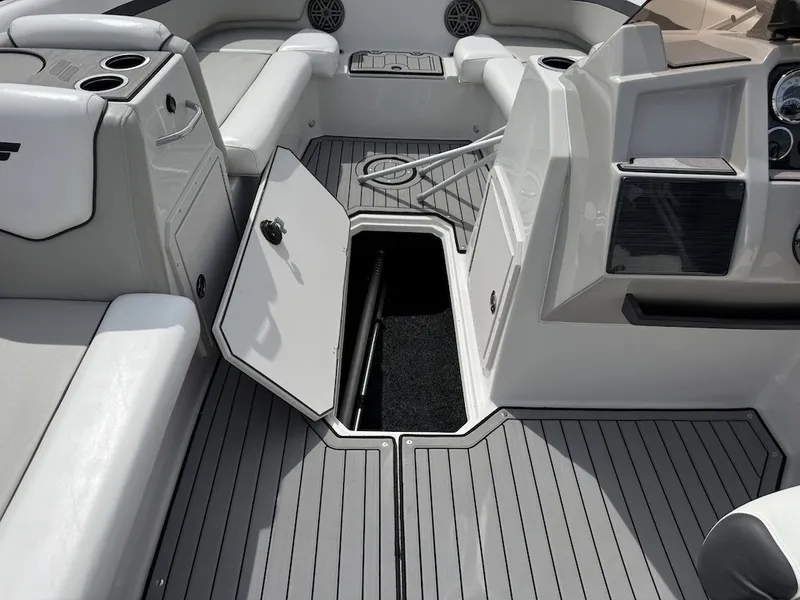 Slide: The Image of The image shows the cockpit of a 2023 Starcraft SVX 211 OB with gray flooring and storage space. - 15
