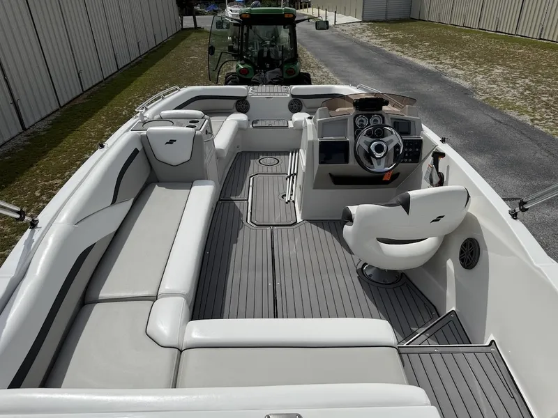 Slide: The Image of The image shows the cockpit of a 2023 Starcraft SVX 211 OB with gray seating and a modern helm. - 5