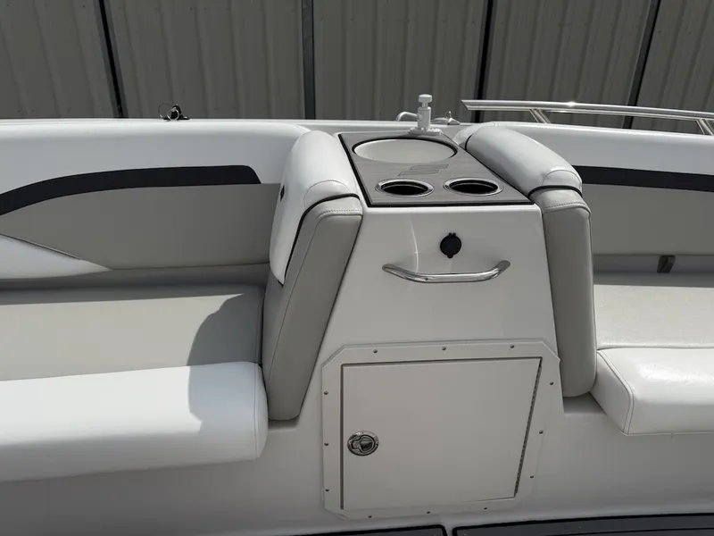 Slide: The Image of The image shows the cockpit of a 2023 Starcraft SVX 211 OB with gray upholstery and cup holders. - 16