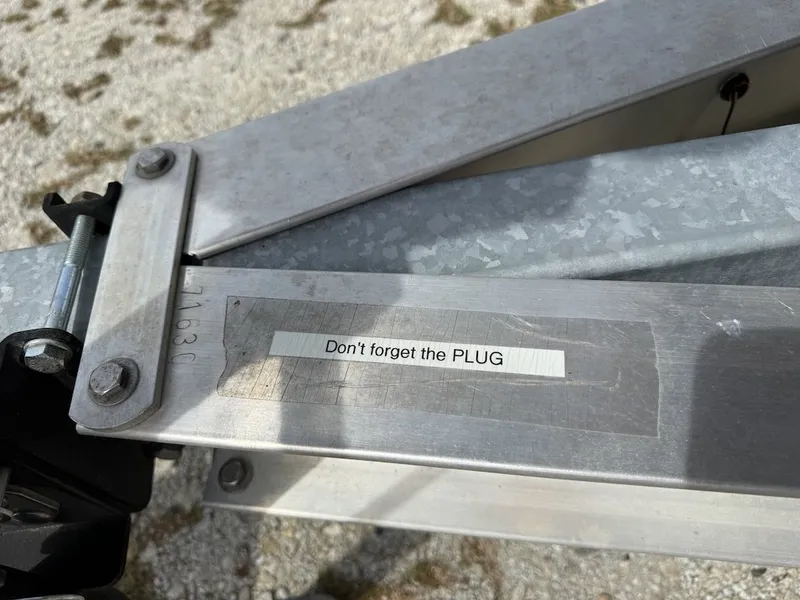 Slide: The Image of A sticker on a boat trailer reminds: "Don't forget the PLUG." - 18
