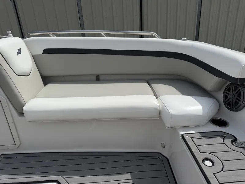 Slide: The Image of The image shows a white bench seat on a boat with gray flooring and a speaker. - 14