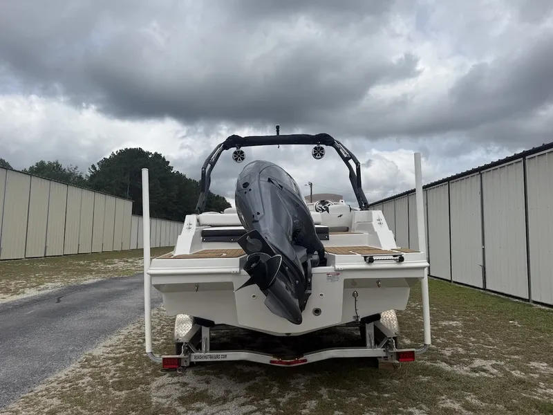 Slide: The Image of A 2025 Starcraft SVX 231 OB boat on a trailer between storage buildings. - 3