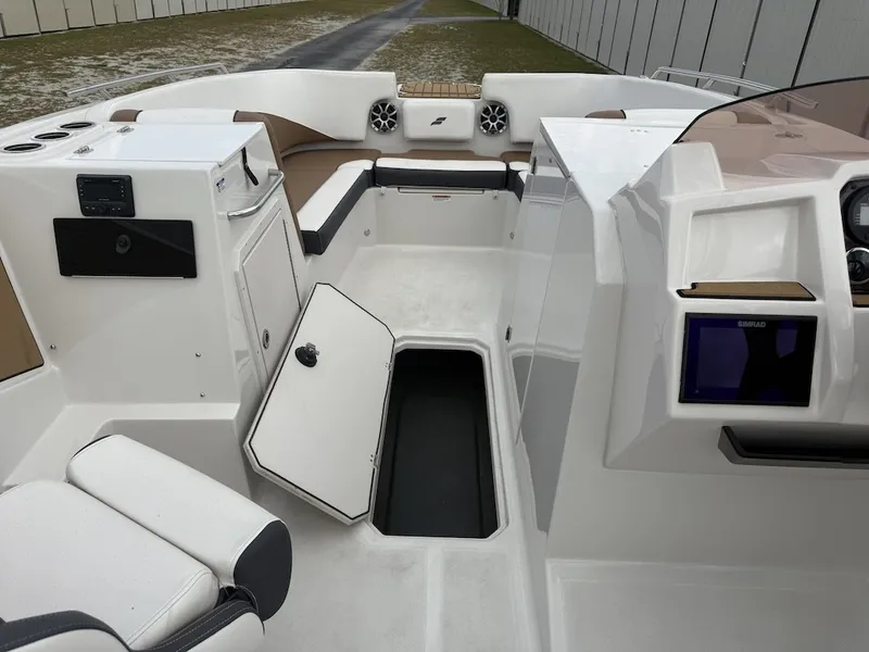 Slide: The Image of The image shows the cockpit of a 2025 Starcraft SVX 231 OB with white and brown seating. - 13