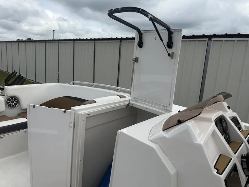 Slide: The Image of The image shows the cockpit of a 2025 Starcraft SVX 231 OB with an open storage compartment. - 12