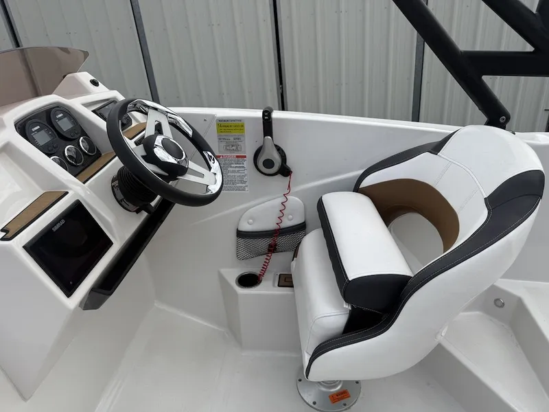 Slide: The Image of The image shows the cockpit of a 2025 Starcraft SVX 231 OB with a modern helm station. - 17
