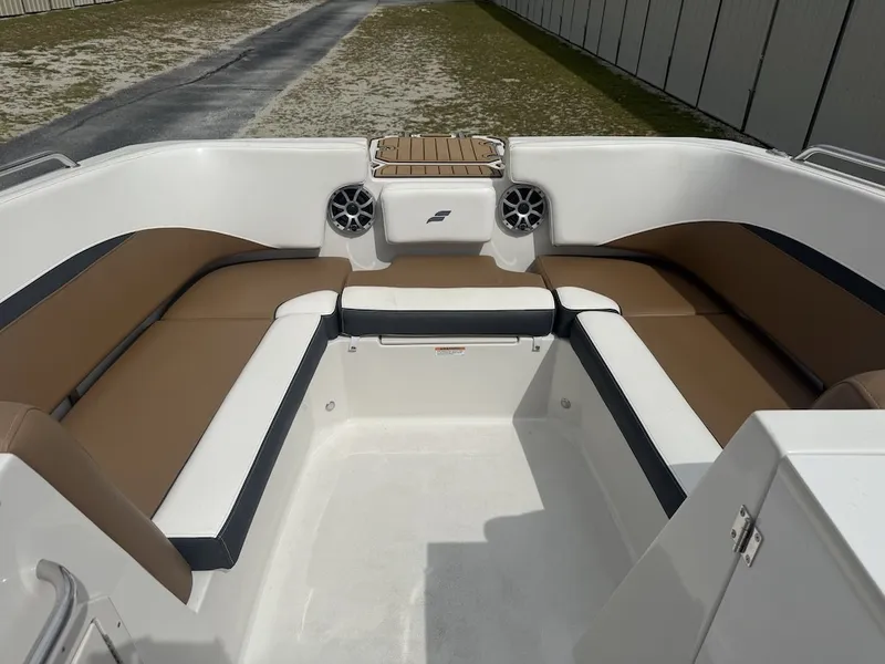 Slide: The Image of The image shows the seating area of a Starcraft SVX 231 OB boat with brown and white upholstery. - 7