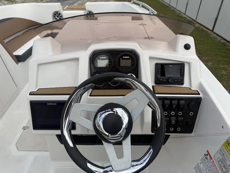 Slide: The Image of The image shows the helm of a Starcraft SVX 231 OB boat with modern instruments. - 18