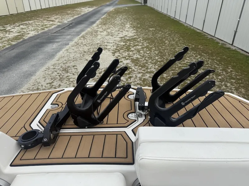 Slide: The Image of The image shows the rear of a boat with modern wakeboard holders. - 11