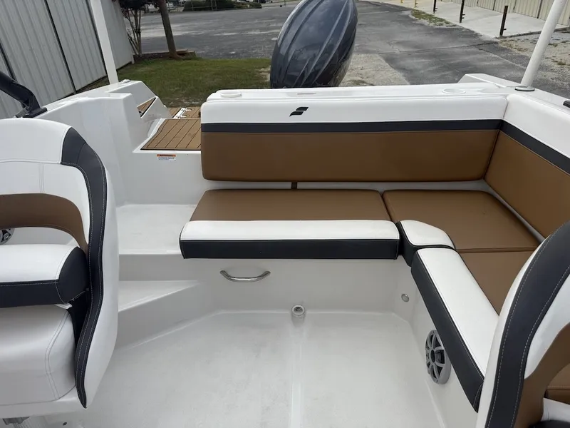 Slide: The Image of The image shows the seating area of a 2025 Starcraft SVX 231 OB boat with brown and white upholstery. - 16