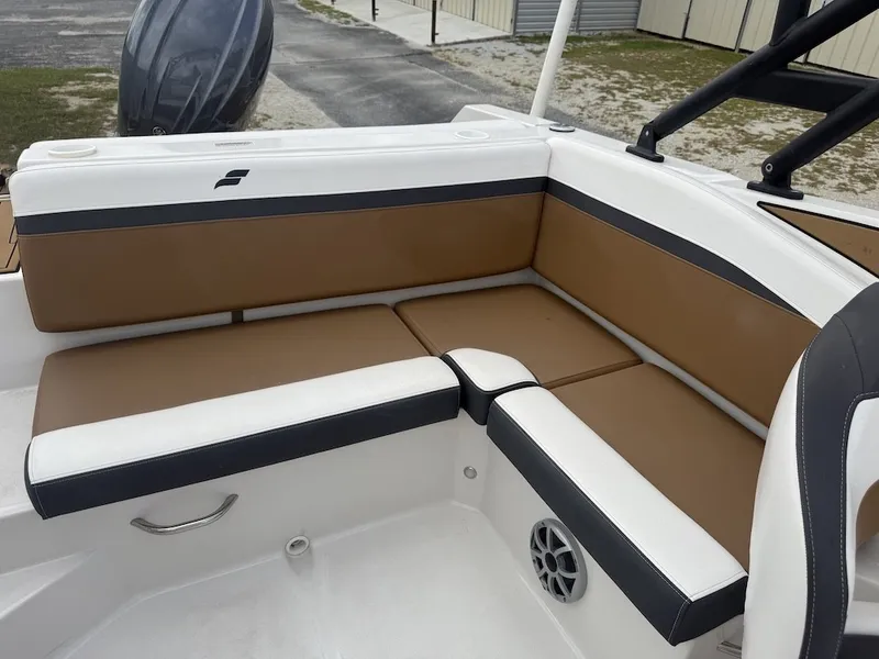 Slide: The Image of The 2025 Starcraft SVX 231 OB features a sleek, cushioned seating area in white and brown. - 15