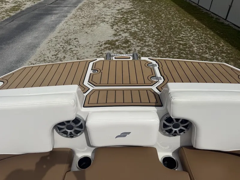 Slide: The Image of The image shows the stern of a Starcraft SVX 231 OB boat with sleek wood detailing. - 8