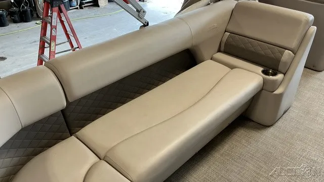 Slide: The Image of Beige upholstered seating with diamond patterns and built-in cup holder on a boat. - 10