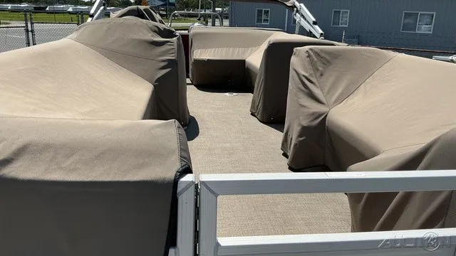 Slide: The Image of The image shows the deck of a 2018 Bennington 22 SLX TRI-LOG S CRUISE PREMIUM with covered seating areas. - 12