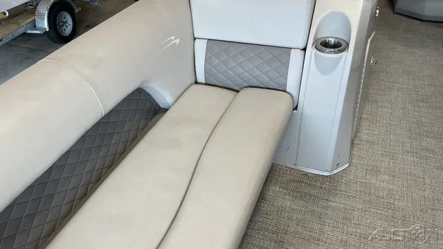 Slide: The Image of Interior of a Bennington 22 SLX TRI-LOG S CRUISE PREMIUM with beige upholstered seating and carpeted floor. - 9