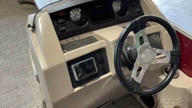Slide: The Image of The image shows the helm of a 2018 Bennington 22 SLX TRI-LOG S CRUISE PREMIUM with a modern steering wheel and instruments. - 5