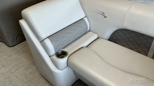 Slide: The Image of The interior of a 2018 Bennington 22 SLX TRI-LOG S CRUISE PREMIUM with gray upholstery and a cup holder. - 8