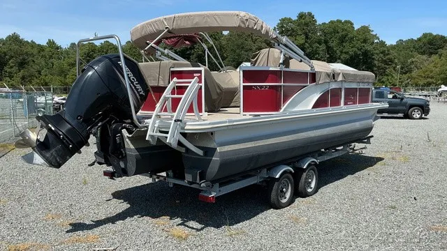 Slide: The Image of A 2018 Bennington 22 SLX TRI-LOG S CRUISE PREMIUM on a trailer, featuring red interior. - 4