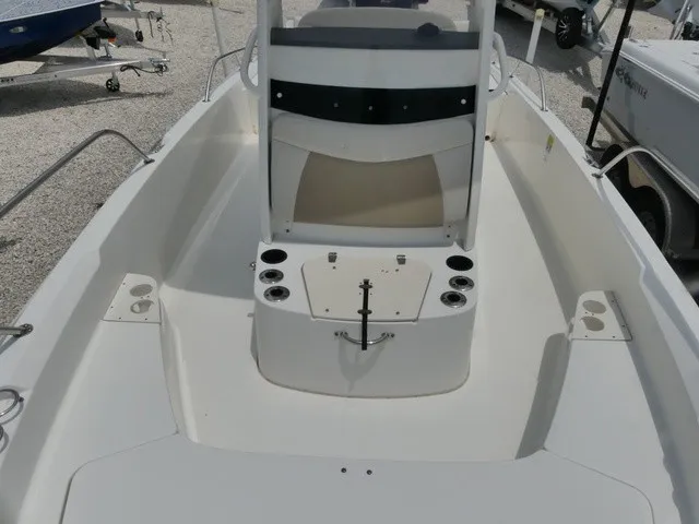 Slide: The Image of The image shows the cockpit of a 2018 Boston Whaler 210 Dauntless with multiple cup holders. - 13