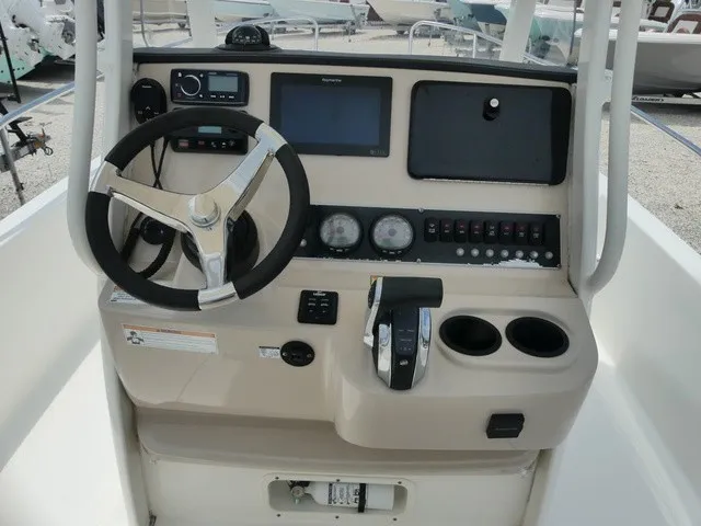 Slide: The Image of The image shows the helm of a 2018 Boston Whaler 210 Dauntless with steering wheel and instruments. - 7