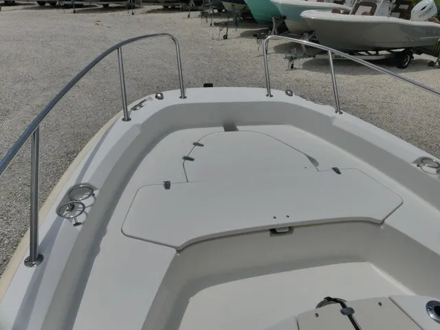 Slide: The Image of The image shows the bow deck of a Boston Whaler 210 Dauntless boat with stainless steel railings. - 11