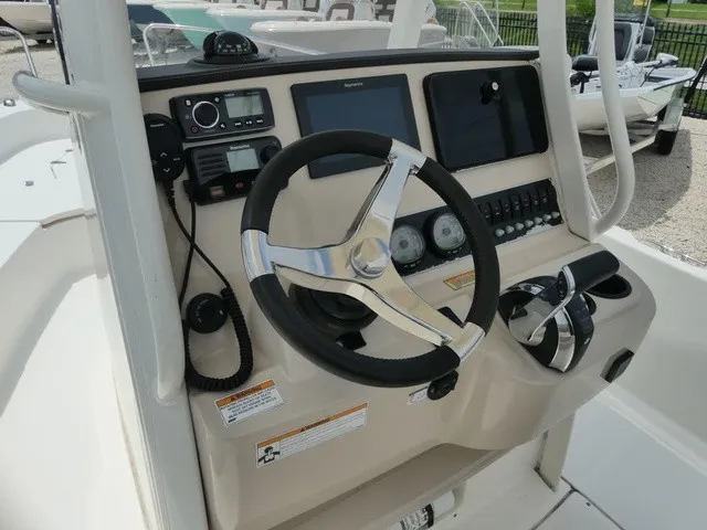 Slide: The Image of The image shows the helm of a 2018 Boston Whaler 210 Dauntless with modern instruments. - 9