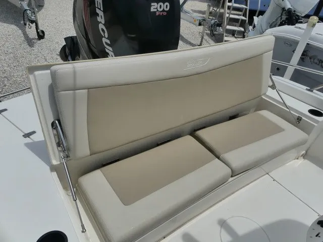Slide: The Image of The 2018 Boston Whaler 210 Dauntless features a beige cushioned bench seat with a backrest. - 5