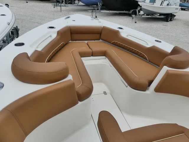 Slide: The Image of The image shows the bow area of a Key West 249 FS boat with brown upholstery. - 12