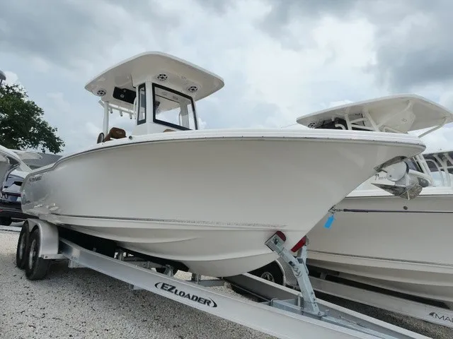 The Image of A white 2026 Key West 249 FS boat on a trailer under a cloudy sky. - 1