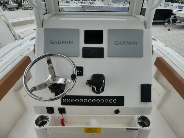 Slide: The Image of The image shows the helm of a Key West 249 FS boat with Garmin screens. - 7