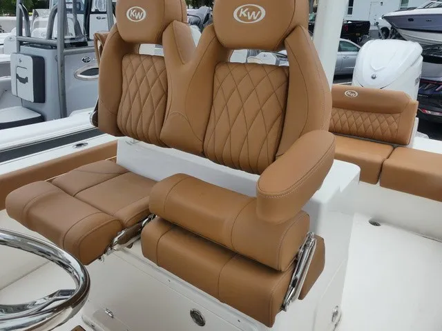 Slide: The Image of The image shows luxurious, cushioned seats on a Key West 249 FS boat. - 10
