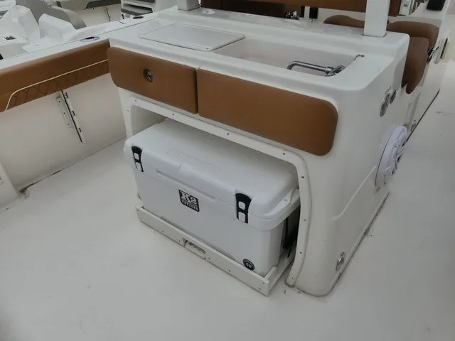Slide: The Image of The image shows the cockpit of a Key West 249 FS boat with a built-in cooler. - 6