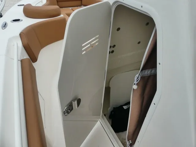 Slide: The Image of The 2026 Key West 249 FS features an open cabin door with brown upholstery. - 11