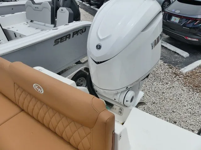 Slide: The Image of A Key West 249 FS boat with a Yamaha outboard motor. It features a brown, cushioned seat. - 4
