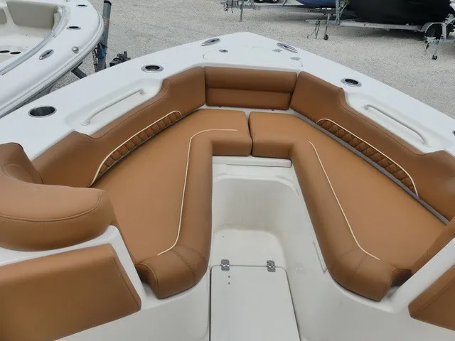 Slide: The Image of The image shows the bow area of a Key West 249 FS boat with brown upholstery. - 13